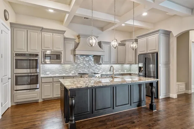 a kitchen with a sink stove and refrigerator