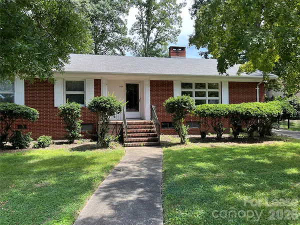 a front view of house with yard and outdoor seating