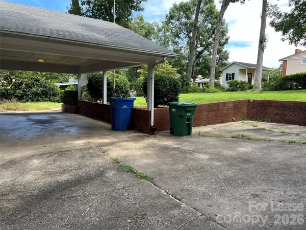 a view of a porch with furniture and a yard