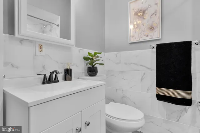 a bathroom with a toilet a sink and mirror