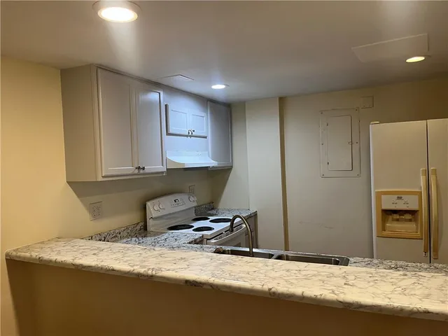 a room with a bed and wooden floor