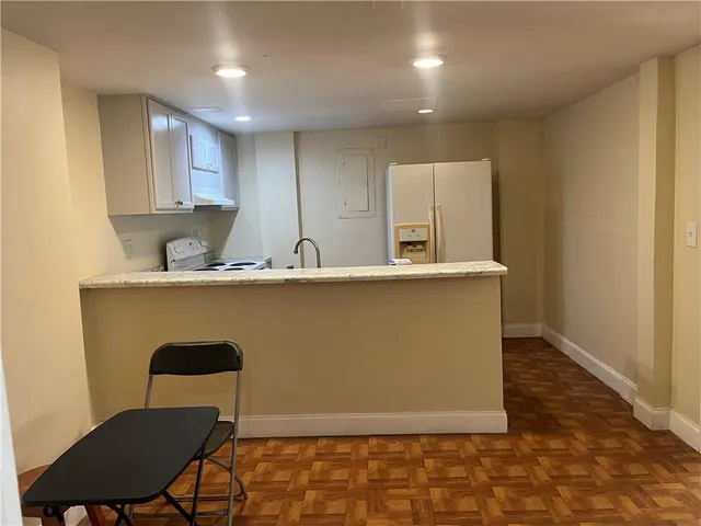 a view of kitchen with granite countertop cabinets table and chairs