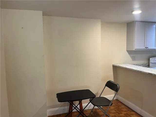 a view of a workspace with furniture and wooden floor