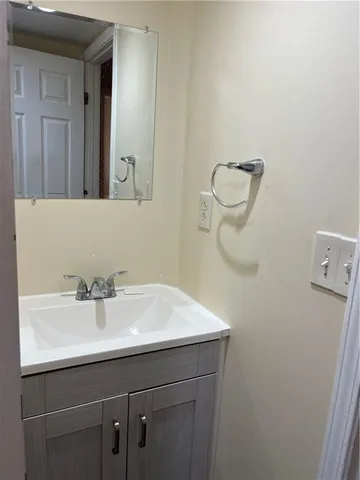 a bathroom with a sink a mirror and vanity