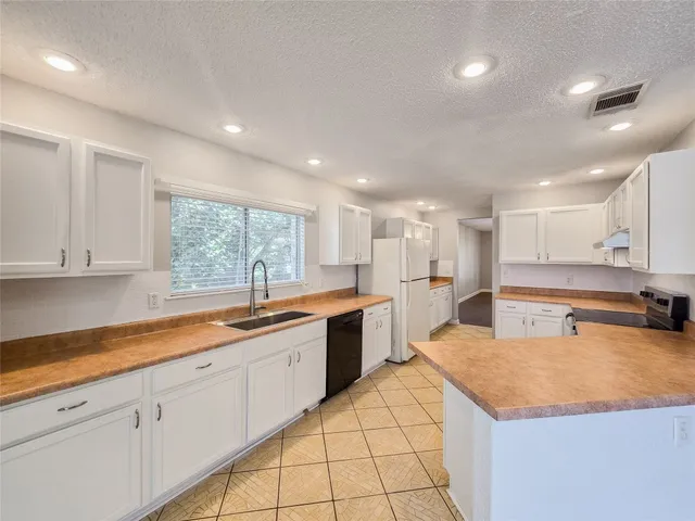 a large kitchen with kitchen island granite countertop a large counter top and sink