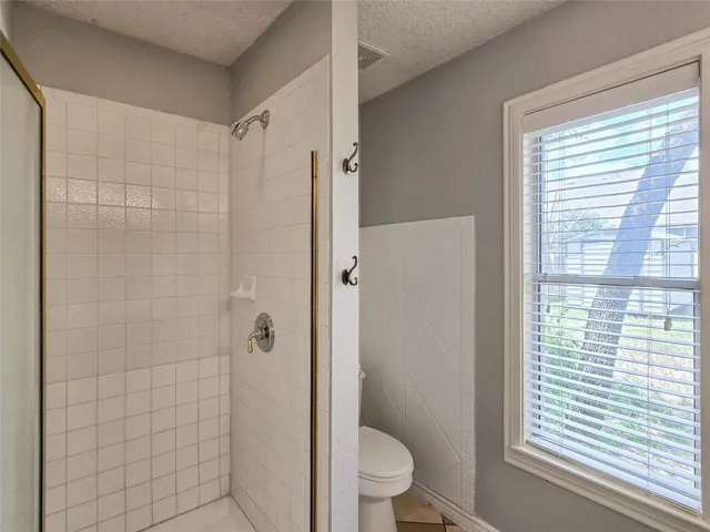 a bathroom with a toilet a sink and shower