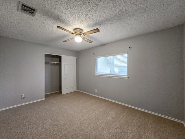 an empty room with a view of a house
