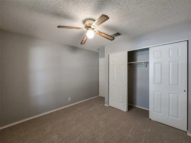 a view of an empty room with a fan