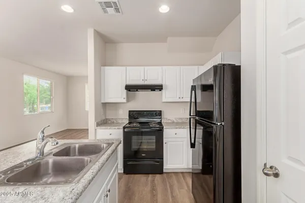 a kitchen with a refrigerator stove and sink