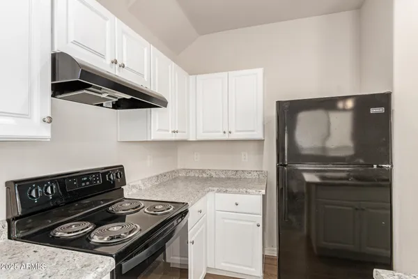 a kitchen with stainless steel appliances granite countertop a stove and a refrigerator
