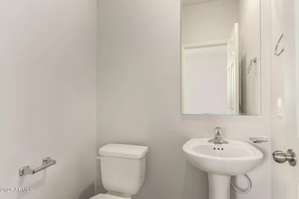 a bathroom with a sink a mirror and a toilet