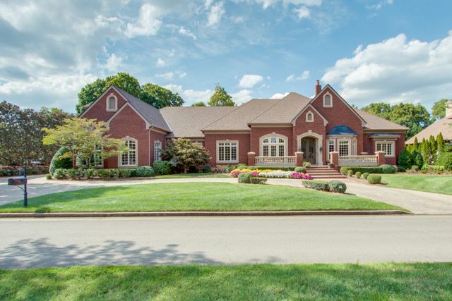 a front view of house with yard and green space