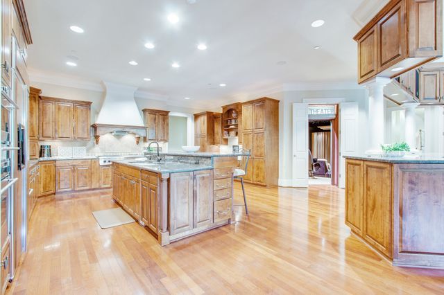 a kitchen with counter top space and wooden floor