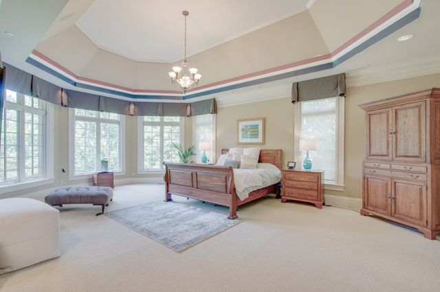 a bedroom with a bed next to a large window