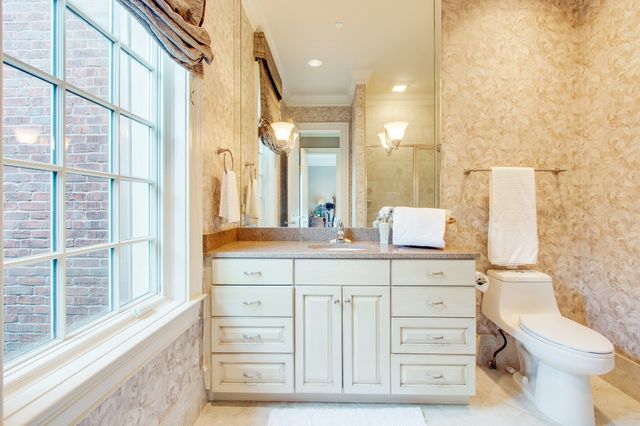 a kitchen with stainless steel appliances granite countertop a sink a stove and cabinets