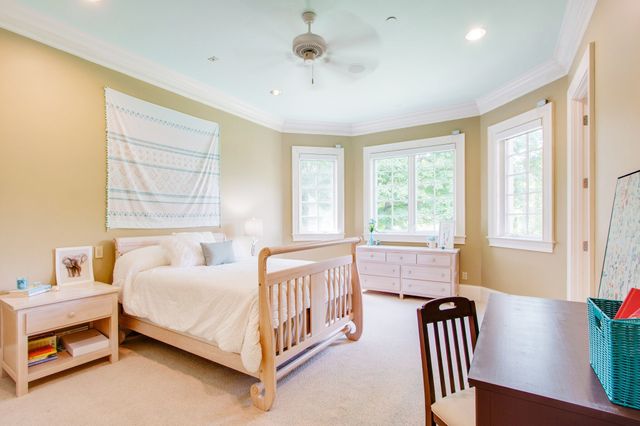 a living room with furniture and floor to ceiling windows