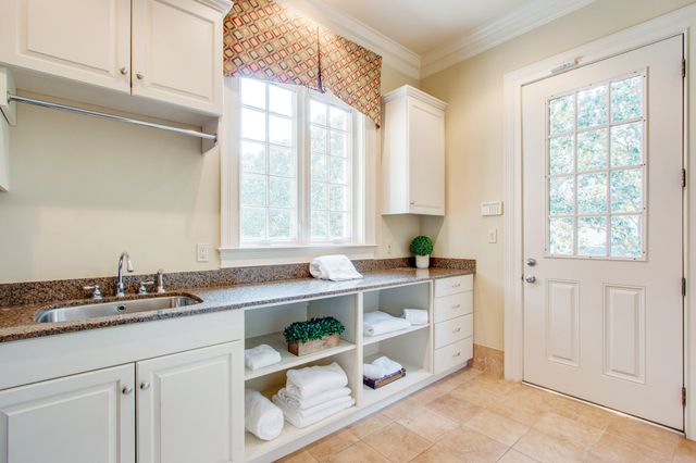 a bath tub sitting in a bathroom next to a window