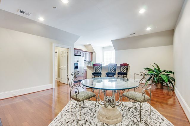 an aerial view of a house with a yard and large trees