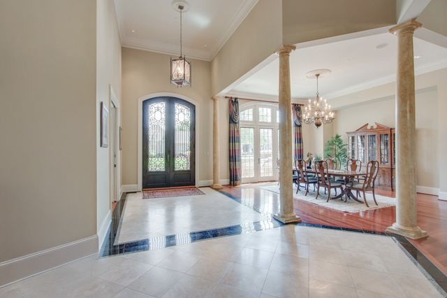a view of a livingroom with furniture and a chandelier fan