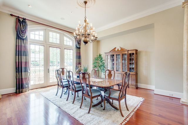 a living room with furniture chandelier and a fireplace