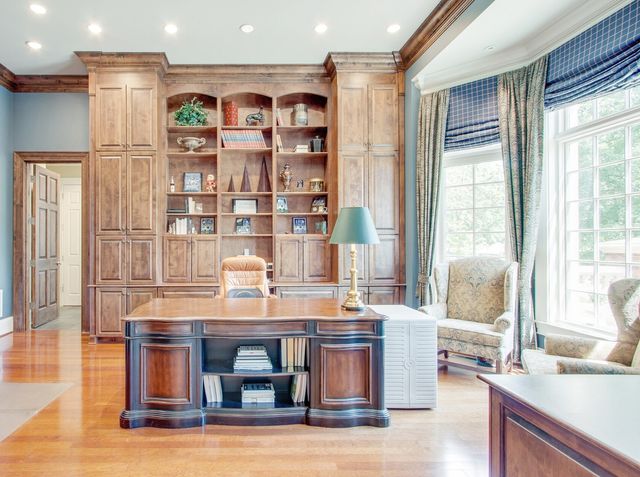 a living room with furniture a fireplace and a chandelier