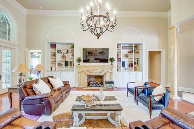 a kitchen with stainless steel appliances kitchen island granite countertop a refrigerator and cabinets