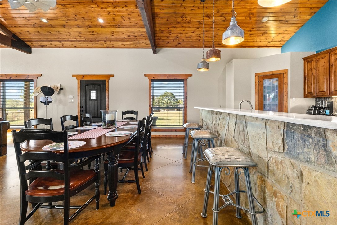 381 Schneider Road Seguin, TX 78155 - Photo 13 of 46 a view of a dining room and livingroom with furniture wooden floor a rug a painting and a chandelier