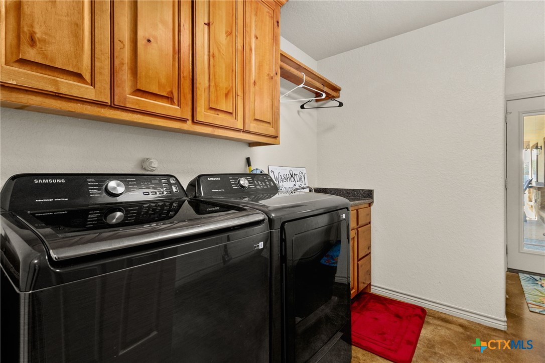 381 Schneider Road Seguin, TX 78155 - Photo 17 of 46 a utility room with dryer washer and a view of living room