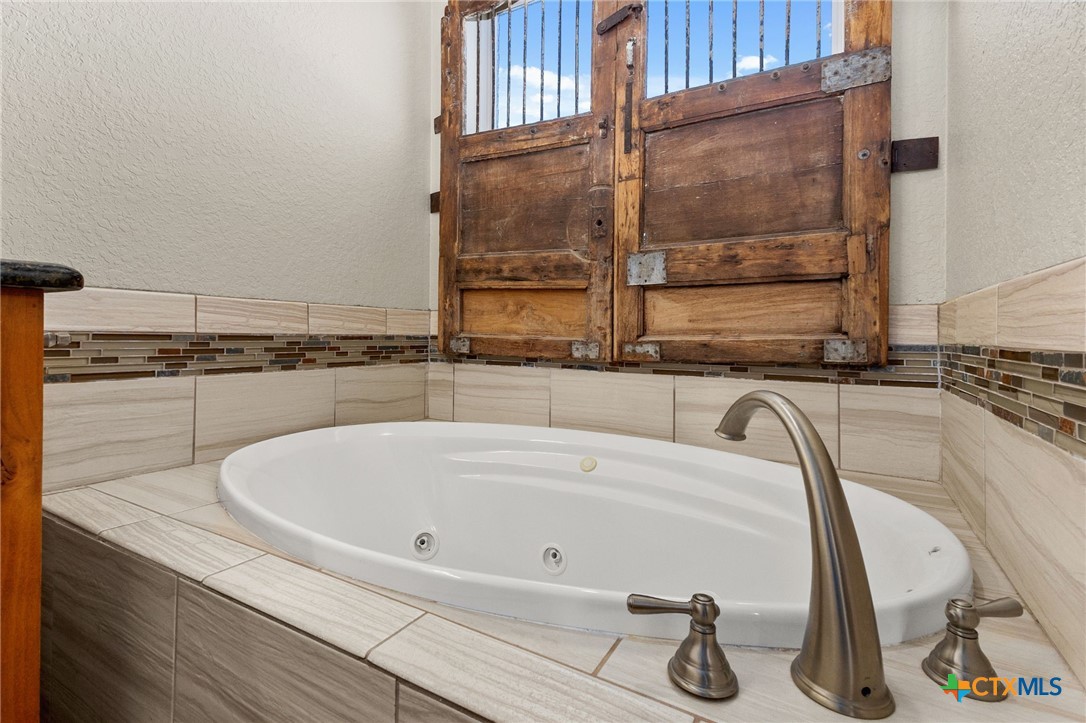 381 Schneider Road Seguin, TX 78155 - Photo 24 of 46 a white bath tub sitting next to a shower