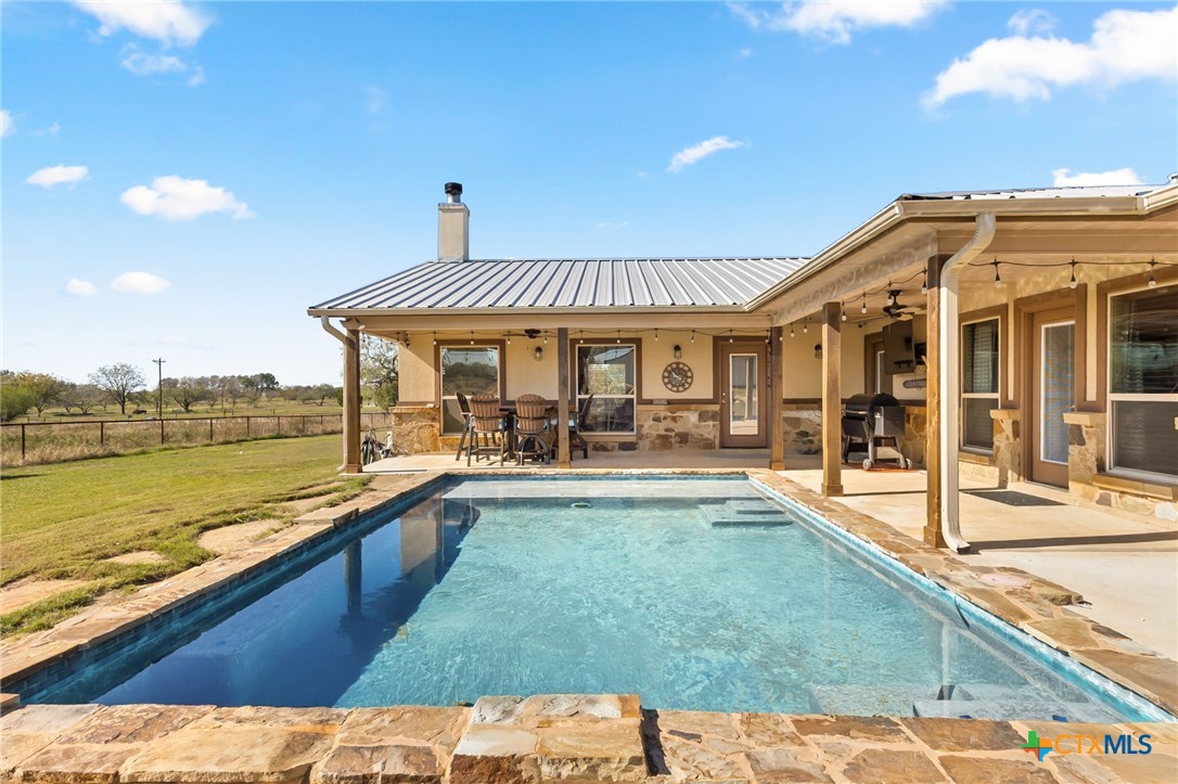 381 Schneider Road Seguin, TX 78155 - Photo 26 of 46 a view of a house with swimming pool and sitting area
