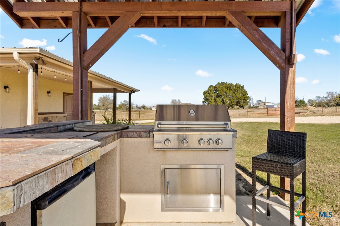 381 Schneider Road Seguin, TX 78155 - Photo 28 of 46 a kitchen with a stove a sink and a refrigerator