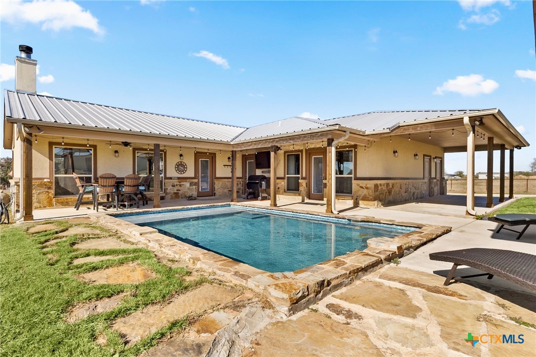 381 Schneider Road Seguin, TX 78155 - Photo 30 of 46 a view of a patio with swimming pool table and chairs