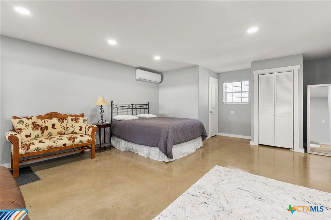 381 Schneider Road Seguin, TX 78155 - Photo 38 of 46 a spacious bedroom with a bed and a couch