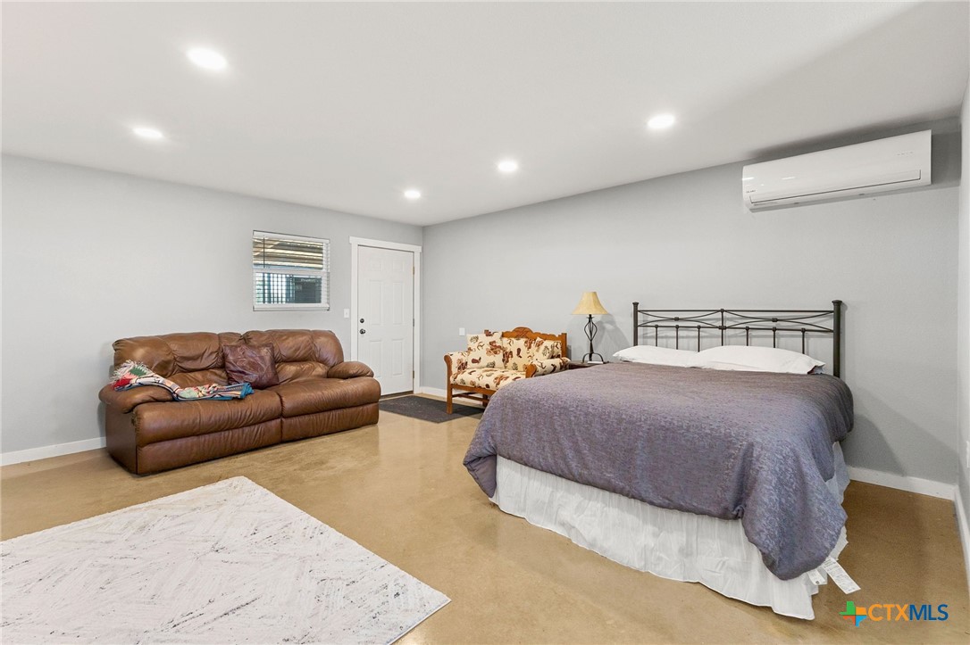 381 Schneider Road Seguin, TX 78155 - Photo 40 of 46 a spacious bedroom with a bed and a couch
