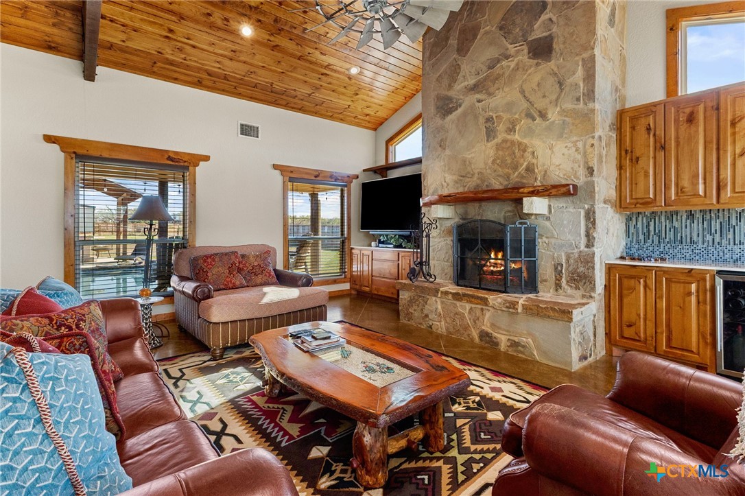 381 Schneider Road Seguin, TX 78155 - Photo 5 of 46 a living room with furniture a fireplace and a flat screen tv