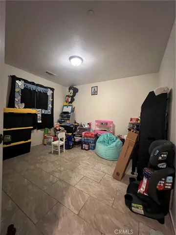 a bedroom with a bed and a television