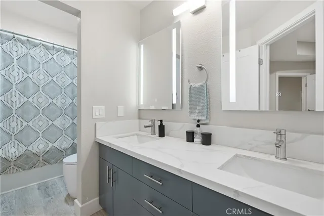 a bathroom with a double vanity sink mirror and double