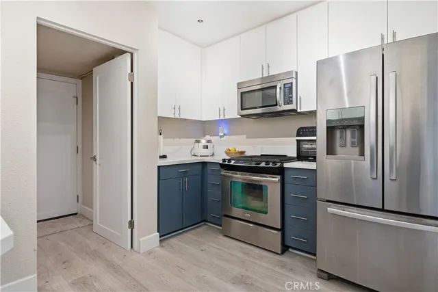 a kitchen with stainless steel appliances granite countertop a refrigerator stove and microwave