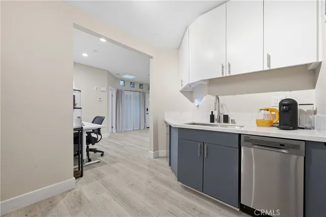 a kitchen with a sink cabinets and appliances
