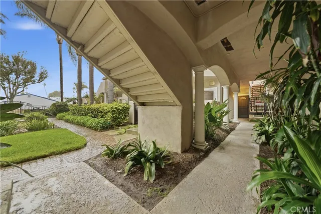 a house with potted plants in front of it