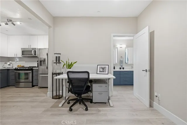 a view of a workspace with furniture and wooden floor