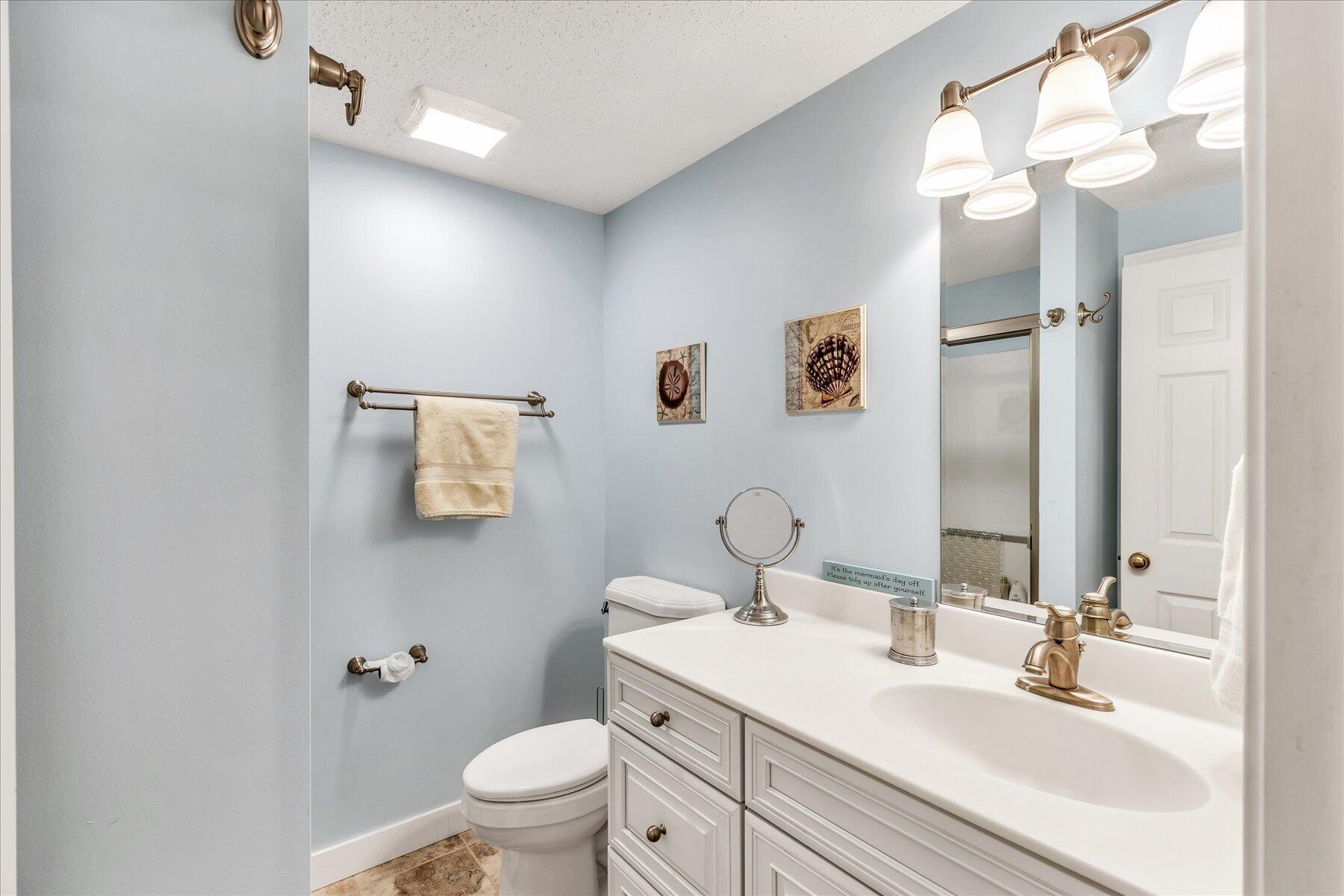 42 Wood Road Mashpee, MA 02649 - Photo 44 of 50 a bathroom with a granite countertop sink toilet and a mirror
