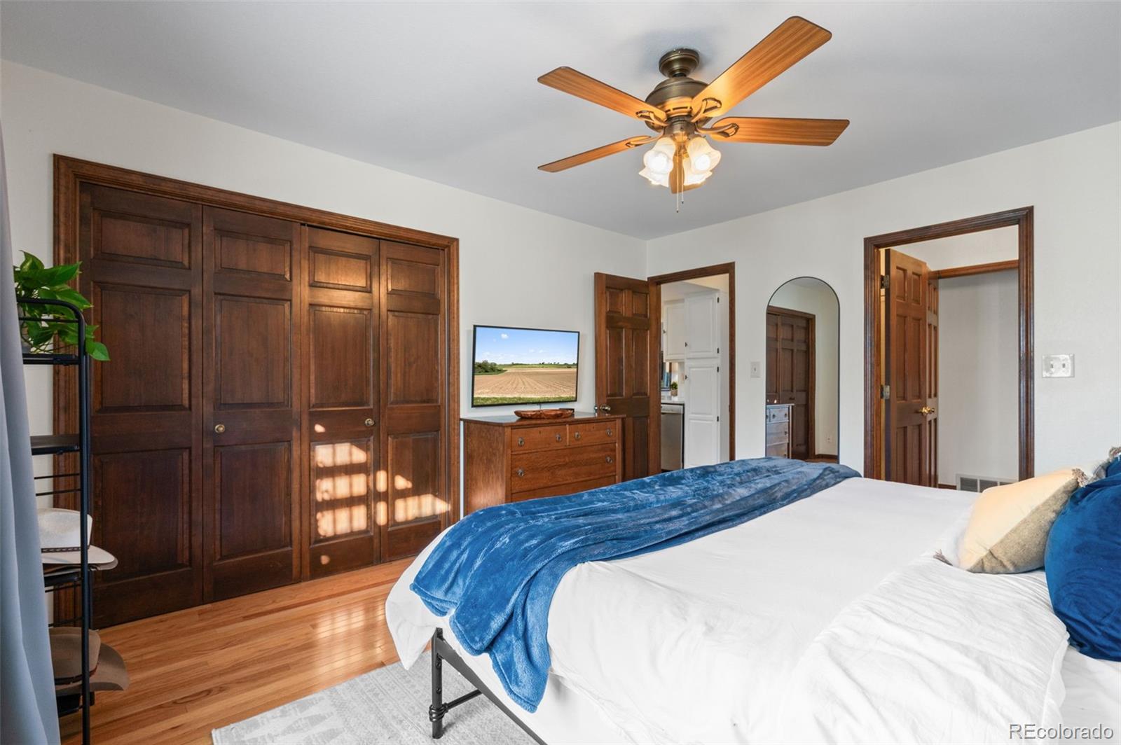 2325 Perry Street Denver, CO 80212 - Photo 14 of 39 a bedroom with a bed and a chandelier