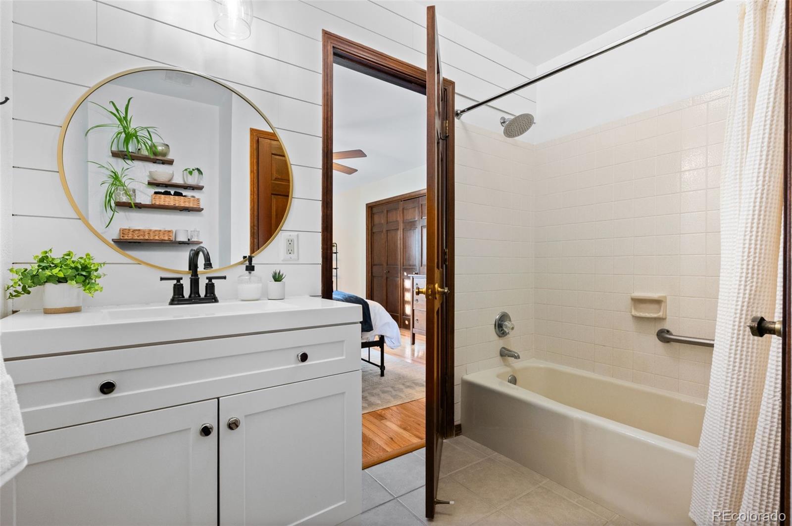 2325 Perry Street Denver, CO 80212 - Photo 16 of 39 a bathroom with a bathtub and a sink