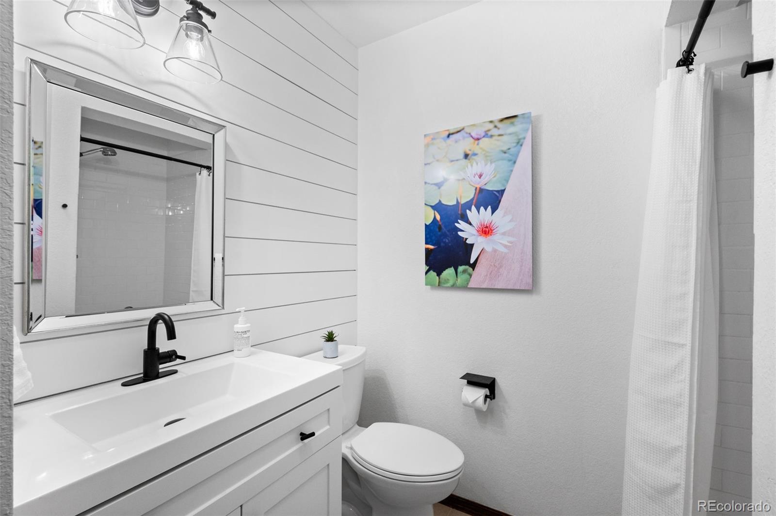 2325 Perry Street Denver, CO 80212 - Photo 25 of 39 a bathroom with a sink mirror and toilet