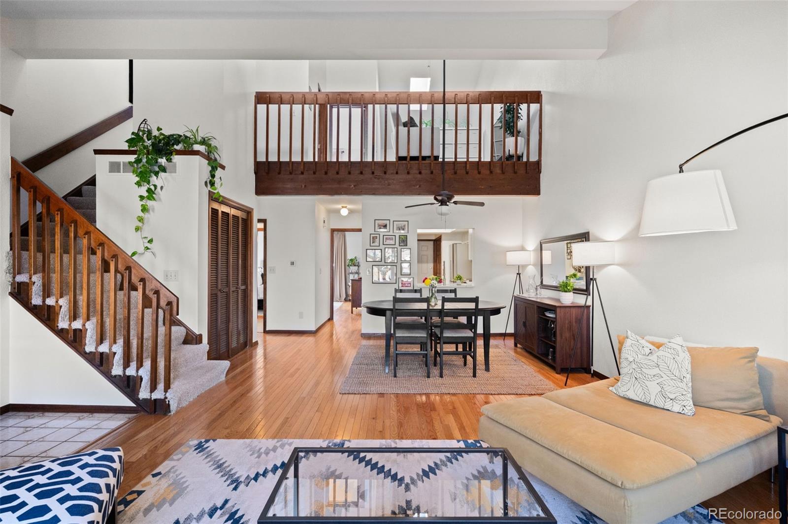 2325 Perry Street Denver, CO 80212 - Photo 5 of 39 a living room with furniture and a dining table