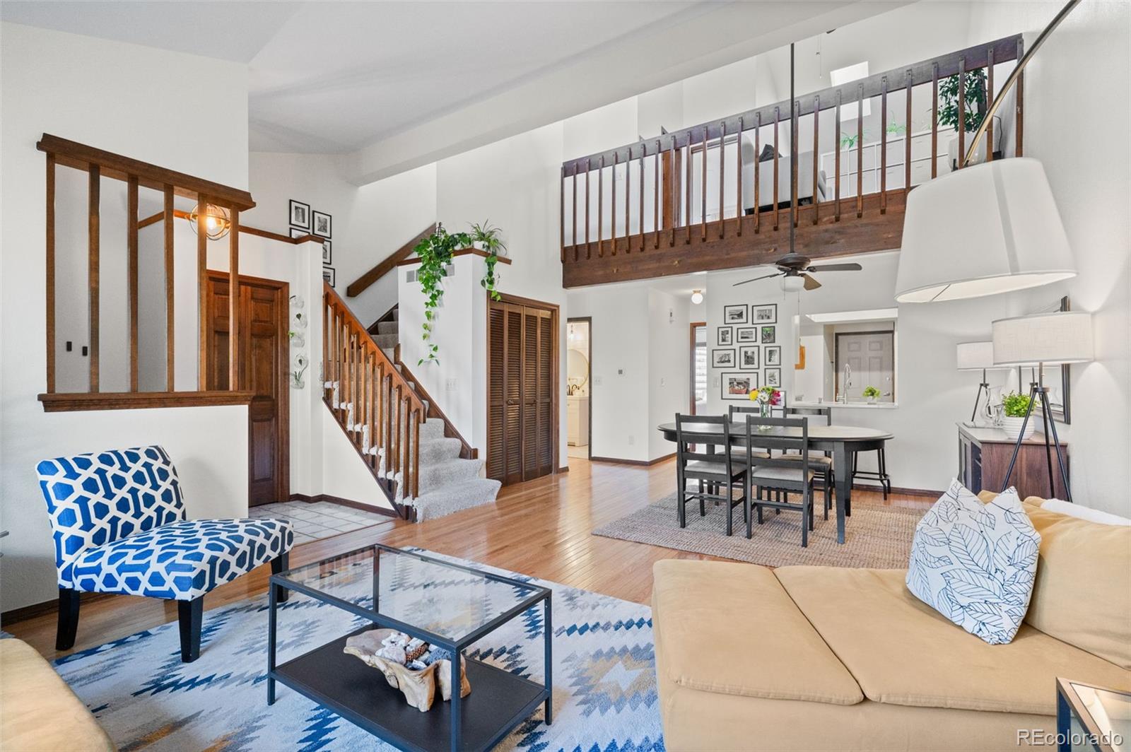 2325 Perry Street Denver, CO 80212 - Photo 6 of 39 a living room with furniture a rug and a chandelier