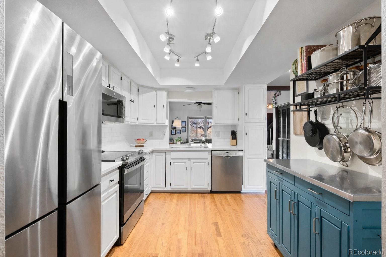 2325 Perry Street Denver, CO 80212 - Photo 9 of 39 a large kitchen with stainless steel appliances granite countertop a sink stove and refrigerator