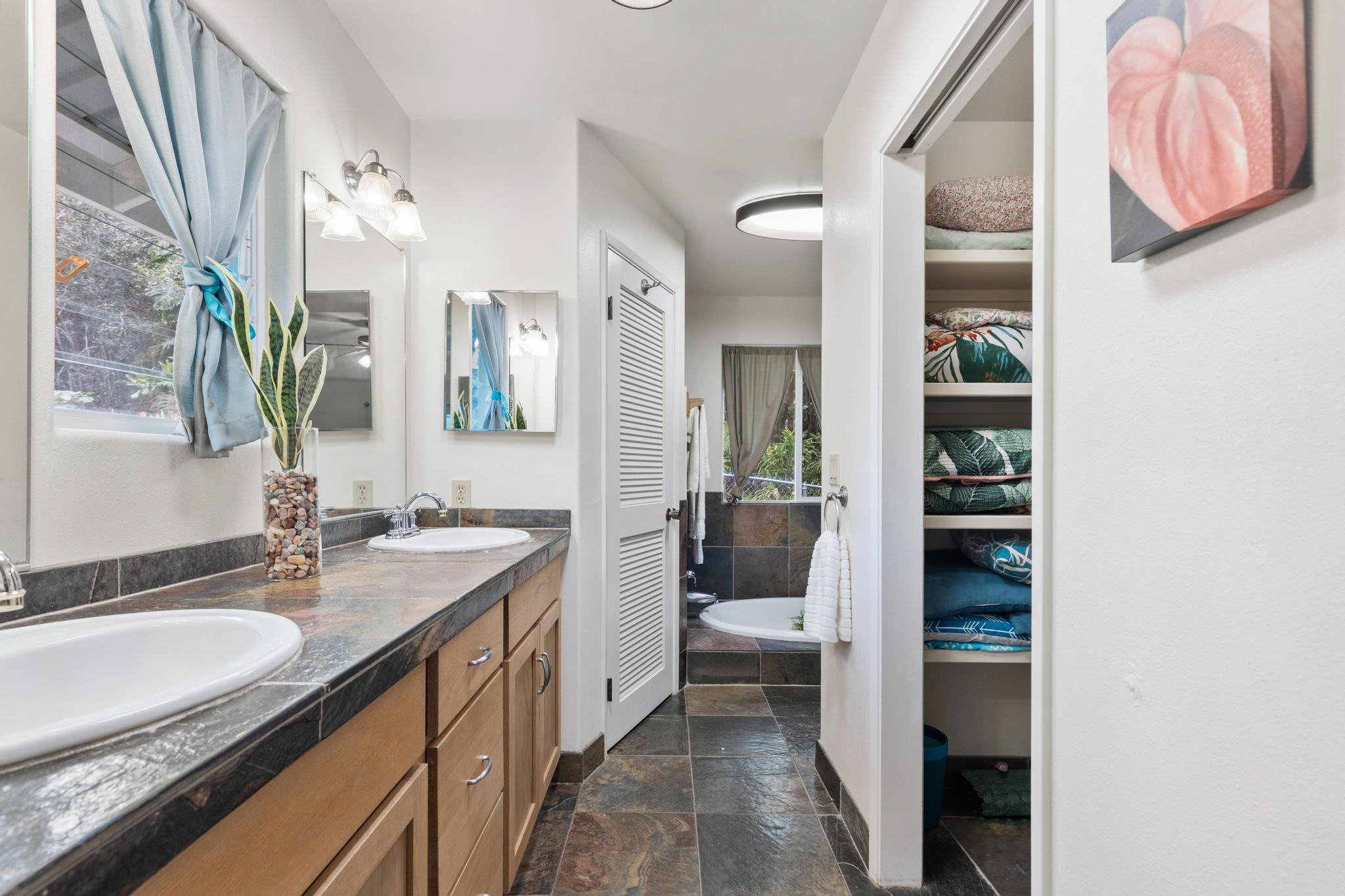 120 Opio Road Hilo, HI 96720 - Photo 11 of 30 a spacious bathroom with a granite countertop sink and a mirror