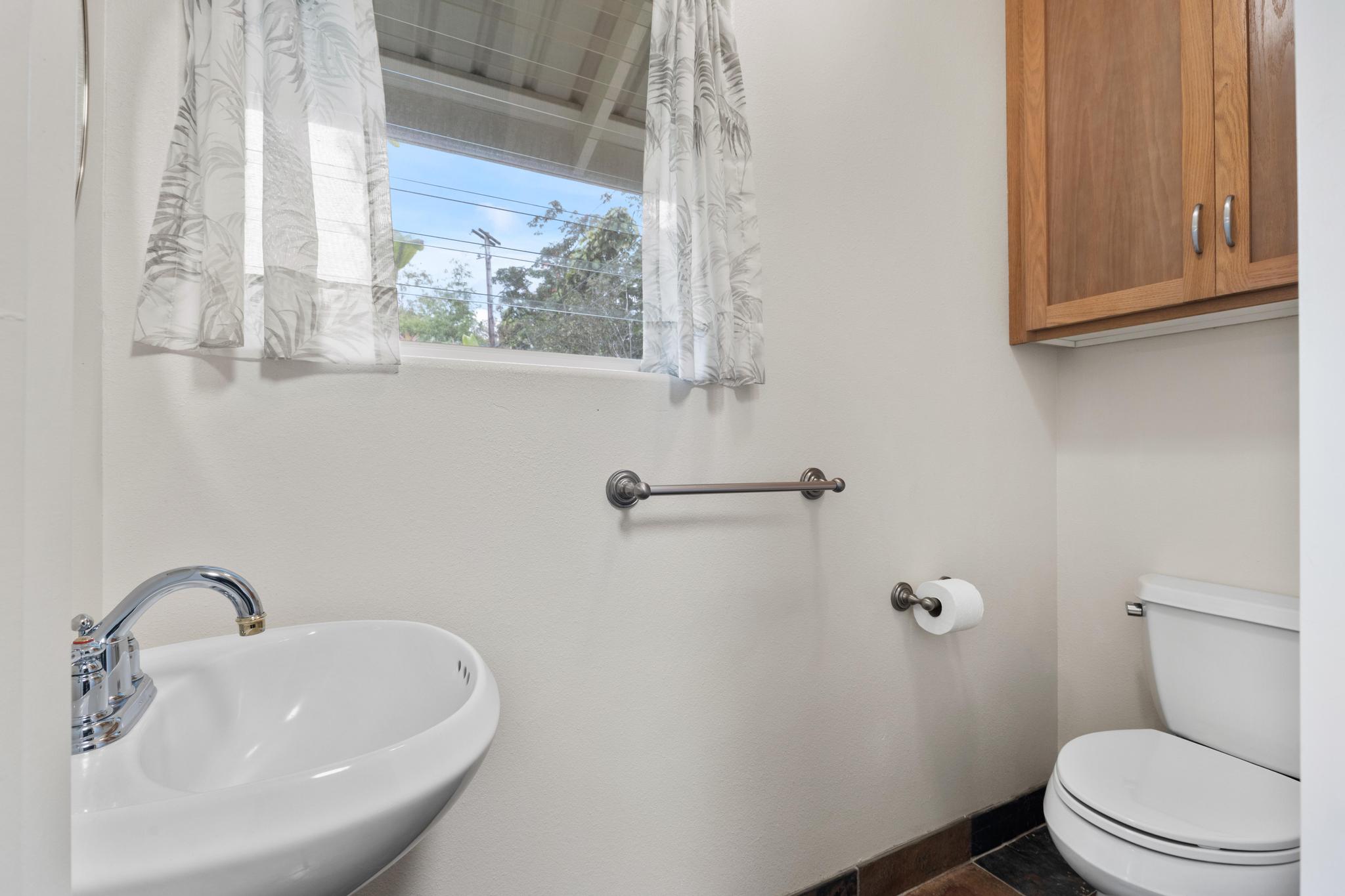 120 Opio Road Hilo, HI 96720 - Photo 14 of 30 a bathroom with a sink a mirror and a toilet